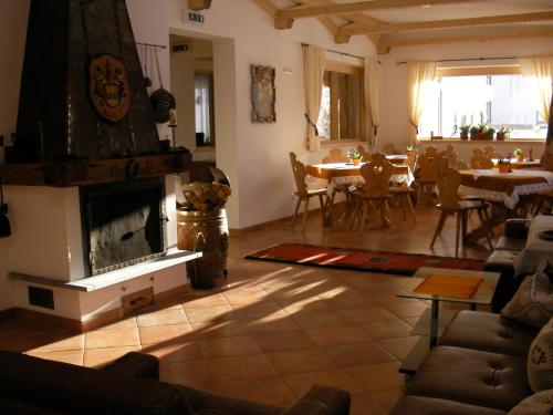 a living room with a fireplace and a dining room at Haus Margreth in Sillian