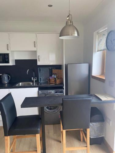 a kitchen with a table and chairs in a kitchen at Ben Nevis Manor Lodge & Indoor Private Hot-Tub in Fort William