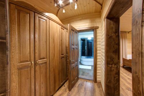 a bathroom with wooden cabinets and a toilet in a room at Lavina Hotel in Bukovel