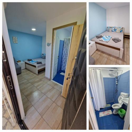 a bathroom with blue walls and a room with a toilet at Pagini Din Vama in Vama Veche