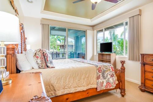 a bedroom with a bed and a desk and a tv at Mauna Lani Resort 1401 in Waikoloa