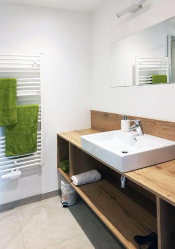 a bathroom with a white sink and a mirror at Ferienwohnungen Brunmayr in Gmunden
