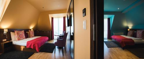 a room with two beds and a desk in it at Tópart Hotel in Balatonvilágos