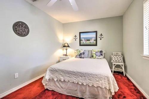 a bedroom with a white bed and a chair at Resort gem w/ 2-bedrooms and easy walk to beach in Panama City Beach