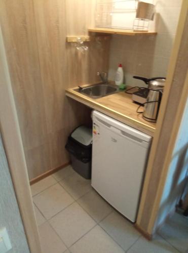 a small kitchen with a sink and a trash can at TäheMaja6 in Viljandi