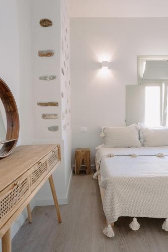 a white room with two beds and a mirror at Domino Syros by SV in Ermoupoli