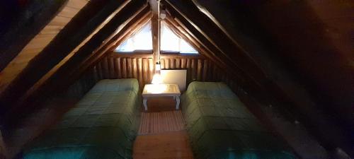 a small room with two beds and a window at Cabana Mamull in La Consulta