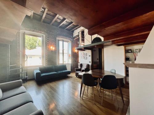 a living room with a couch and a table and chairs at La Casa sul Naviglio in Milan
