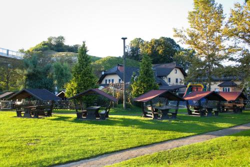 a park with benches and a playground in the grass at Črni Baron Pension Black Baron in Maribor