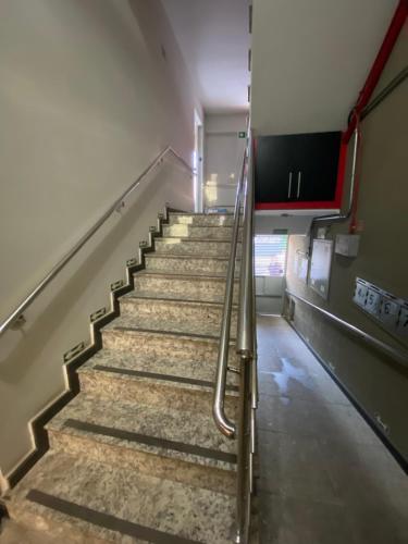 a flight of stairs in an empty building at Apart Hotel Seg Total Lofts Encantadores in Mogi-Guaçu