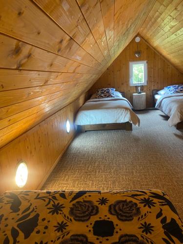 a bedroom with two beds in a attic at Apartmany Silver in Rokytnice nad Jizerou