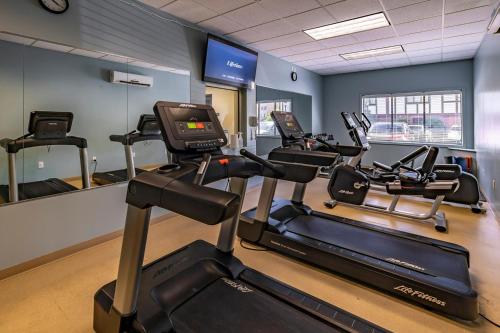 a gym with several cardio machines in a room at The English Inn of Charlottesville in Charlottesville