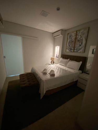 a bedroom with a large bed and a window at Apart Hotel Seg Total Lofts Encantadores in Mogi-Guaçu