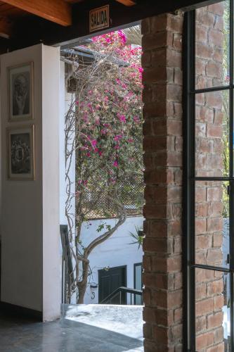 a door to a building with a window with flowers at The Lot Boutique in Lima