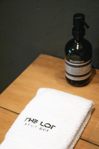 a bottle of the lotion on a table with a napkin at The Lot Boutique in Lima