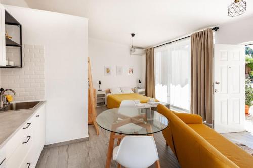 een keuken en een woonkamer met een bank en een tafel bij Sintra Studio Garden - Free Parking in Sintra