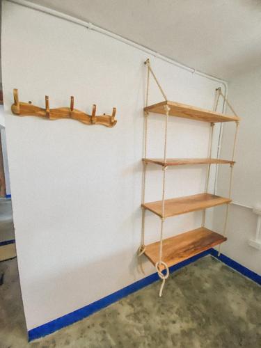 a shelf in a room with a white wall at Mamallena Beachside Rincon del Mar in Rincón