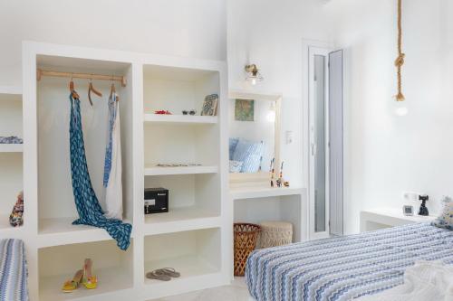 a bedroom with white shelves and a bed at Ma mer in Naxos Chora