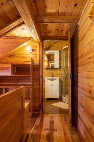 an inside view of a cabin with wooden walls and wood floors at Kuća za odmor Lara in Otočac