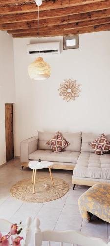 a living room with a couch and a table at Anemone traditional house in Lartos