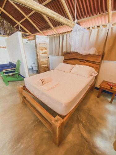 a bedroom with a bed on a wooden platform at Mamallena Beachside Rincon del Mar in Rincón
