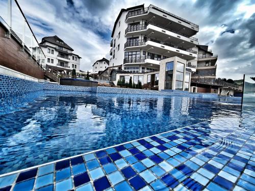 a swimming pool in front of a building at Milmari S70 Kopaonik in Kopaonik