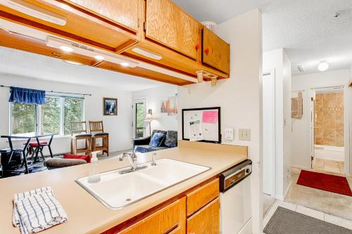a kitchen with a sink and a living room at Grandview Condo in Breckenridge