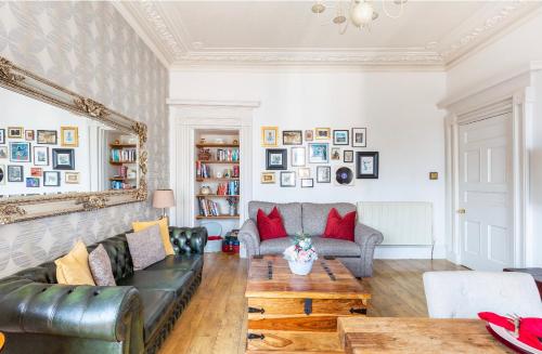 a living room with a couch and a table at Heart of Ayr: elegant townhouse in central Ayr in Ayr