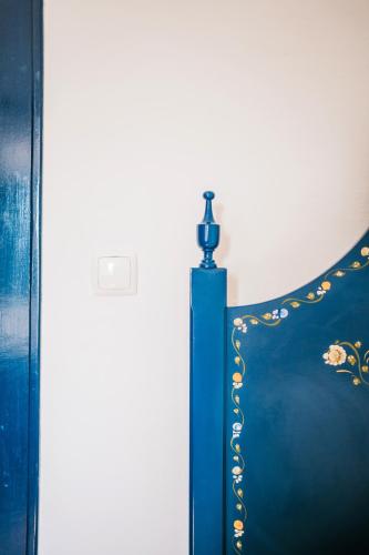 a blue chair with a bottle on top of it at O Conventinho in Évora