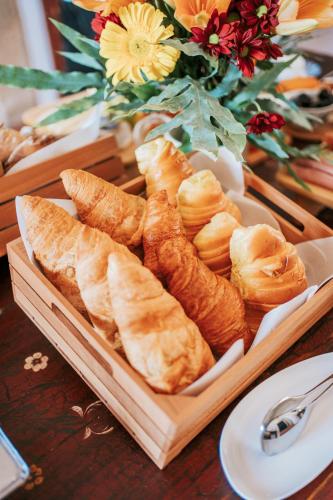 a tray of bread and pastries on a table at O Conventinho in Évora