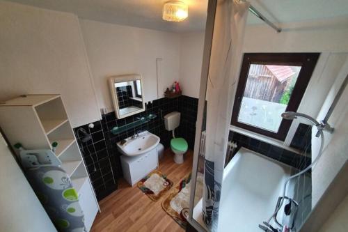 a small bathroom with a tub and a sink at fun4all-holidayhome in Medebach
