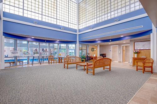 a lobby with wooden benches and tables and windows at Bear Trap Dunes - 51 Tulip Poplar in Ocean View