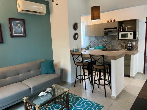 a living room with a couch and a kitchen at Villa 38 in Playa del Carmen