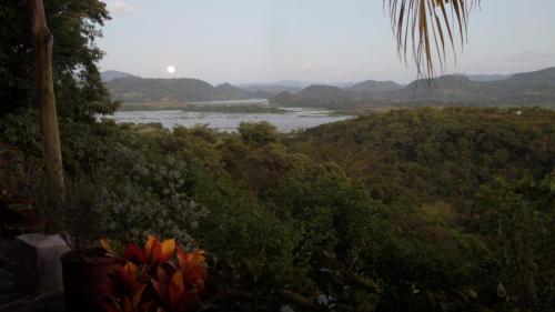 a view of a river with mountains in the background at The Mayan Grouper in Suchitoto