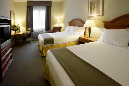 a hotel room with two beds and a flat screen tv at Holiday Inn Express Hotel & Suites 1000 Islands - Gananoque, an IHG Hotel in Gananoque