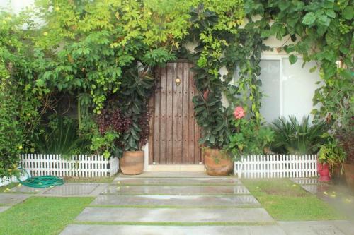 a front door of a house with a bunch of plants at Hacienda en Primavera, descanso Familiar total in Puerto Vallarta