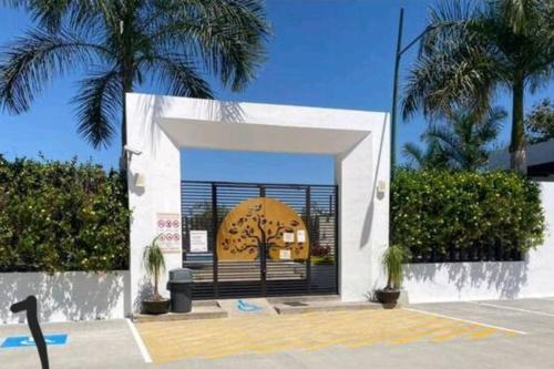 a building with a door with a palm tree at Hacienda en Primavera, descanso Familiar total in Puerto Vallarta