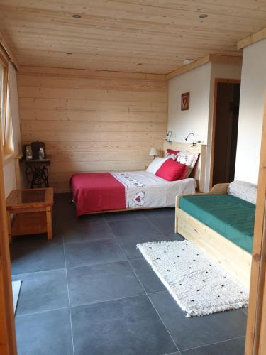 a bedroom with two beds in a wooden cabin at L'Eterlou 74 in Sallanches