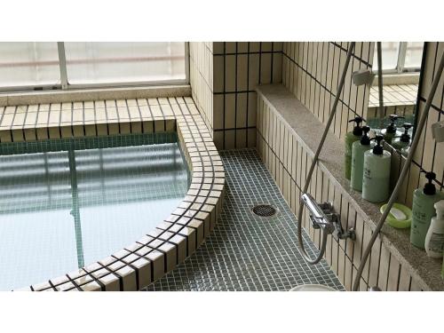 a swimming pool in a bathroom with a sink at Kagetsu Ryokan - Vacation STAY 04876v in Shizuoka