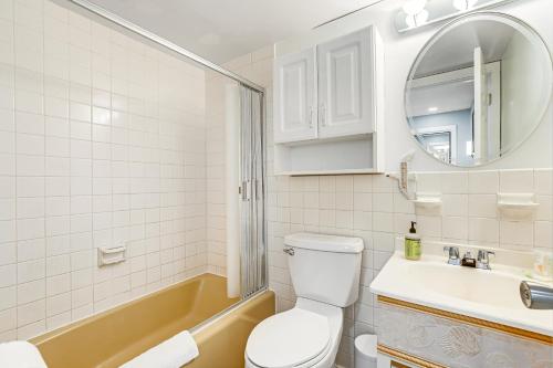 a bathroom with a toilet and a sink and a tub at Rehoboth Beach --- 23 Maryland Ave #500 - Tidewater House in Rehoboth Beach