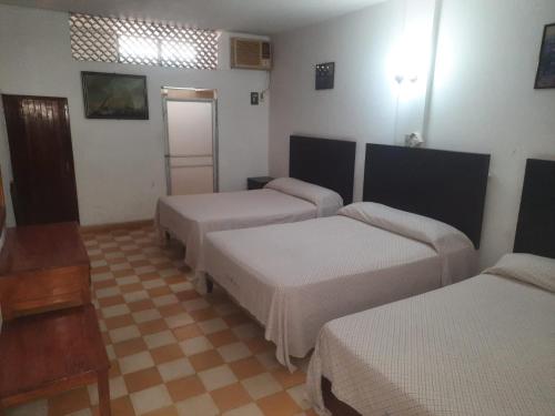 Katil atau katil-katil dalam bilik di HOTEL ACUARIO CATEMACO