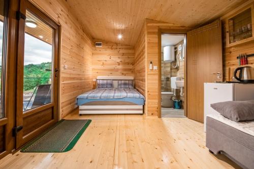 a bedroom in a tiny house with a bed at Sunny in Nikšić