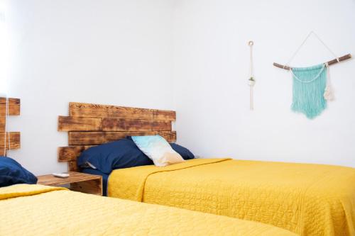a bedroom with two beds with yellow sheets at Isla Venados Renta Vacacional in Mazatlán
