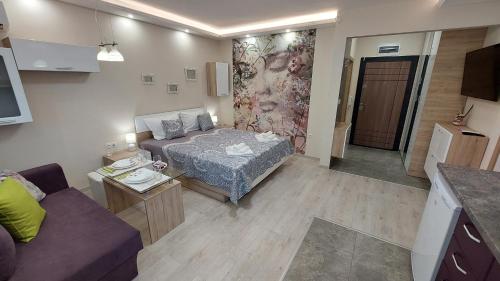 a small room with a bed and a couch at Sunrise City A1, Sarafovo in Burgas