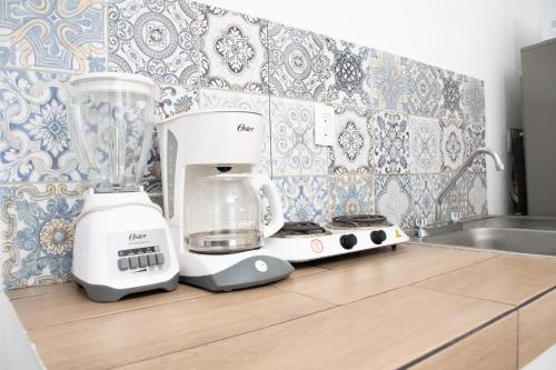 a kitchen counter with a mixer and a blender on it at Isla Venados Renta Vacacional in Mazatlán