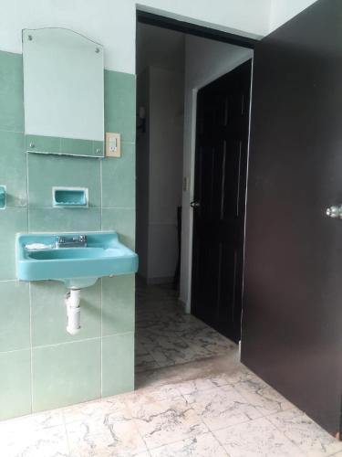 a bathroom with a blue sink and a mirror at HOTEL ACUARIO CATEMACO in Catemaco