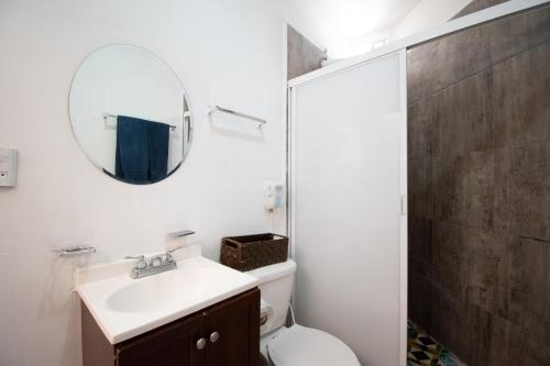 a bathroom with a toilet and a sink and a mirror at Isla Venados Renta Vacacional in Mazatlán