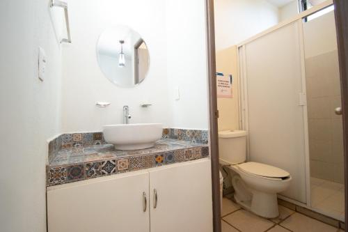 a bathroom with a sink and a toilet at Isla Venados Renta Vacacional in Mazatlán