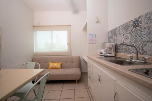a kitchen with a couch and a sink in a kitchen at Isla Venados Renta Vacacional in Mazatlán