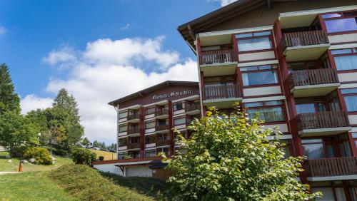 a building with balconies on the side of it at Studio 20qm mit Balkon und Innenpool - 22031 in Schluchsee
